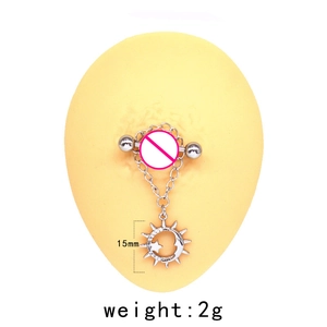 Macro detail of silver nipple ring with sun moon star pendants on 15mm steel barbell