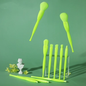 Neon green makeup brush set displayed on clear acrylic stands with creative floating layout