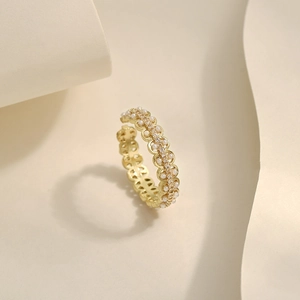 Detail of gold open ring with hollow wave design, pearls and zircon insets