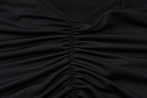Détail du décolleté en V avec un design froncé vertical sur un tissu noir élastique