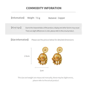 Detailed close-up of vintage bell tassel earrings with gold plating and copper texture