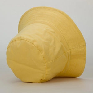 Close-up of bright yellow cotton bucket hat with multi-row stitching on brim