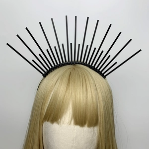 Detail of a black halo headband with radial plastic spikes on a mannequin with gold hair