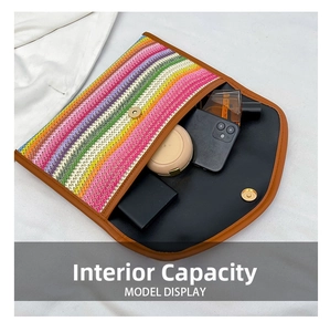 Rainbow striped straw envelope clutch showing interior capacity for phone and cosmetics