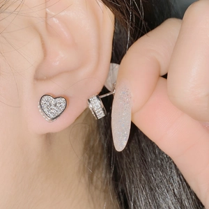 Macro shot of silver heart stud earrings with sparkling pavé micro-inlaid zircon stones
