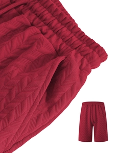 Detailed macro view of the dark red shorts showing the texture and drawstring waistband