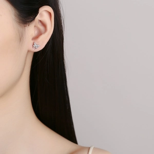 Elegant 925 sterling silver butterfly stud earrings with sparkling crystals on model