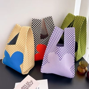 Detail showing four knit checkered handbags with heart patterns in vibrant colors