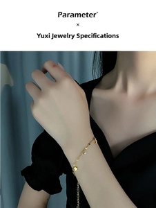 Detailed view of a gold titanium anklet featuring star and moon pendants with zircon