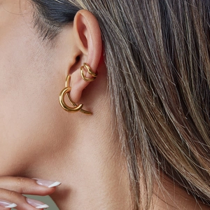 Minimalist gold hoop earrings and ear cuff set worn by a model for a stylish look