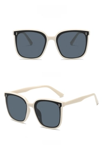 Front and 45-degree side view of oversized cream frame sunglasses with dark grey lenses