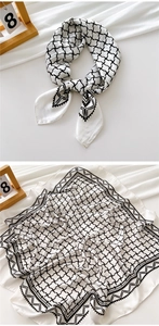Macro view of a 70cm square silk scarf featuring black and white geometric grid patterns