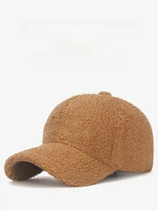 Detailed close-up of brown sherpa baseball cap with white WHO-NOA embroidery