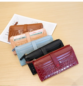 Detail of stone pattern long wallets in various colors on a stylish wooden background