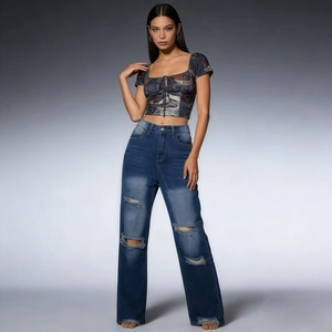 Close-up of high-waist straight jeans with distressed knees and frayed fringe hems