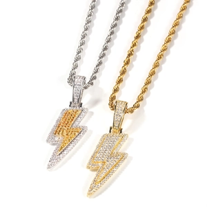 Close-up of gold and silver lightning bolt pendants with cubic zirconia on rope chains