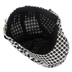 Detail of 100% cotton inner lining and sweatband of a black and white plaid ivy cap