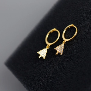 Macro shot of gold Christmas tree hoop earrings with sparkling white zirconia crystals