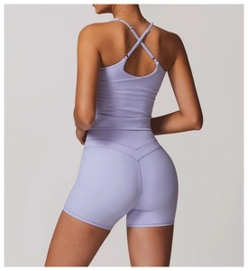 Detail of light purple yoga tank top featuring a criss-cross back and elastic fabric