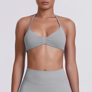 Detail view of seamless grey halter yoga sports bra and high-waist compression leggings set