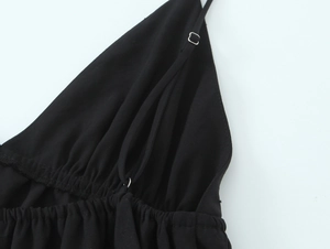 Detail of adjustable strap and gathered neckline on black camisole top for women