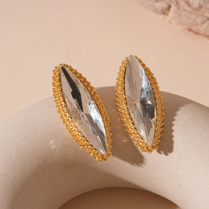 Detailed macro view of marquise cut crystal earrings with vintage gold beaded edges