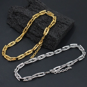Elegant gold and silver titanium steel link chain necklaces set on a textured dark background