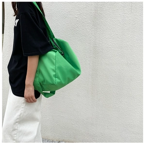 Modern neon green large capacity oxford fabric tote bag shown on a model outfit