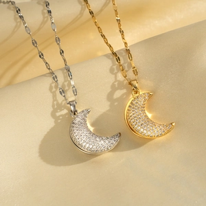 Detail of moon pendant necklaces in gold and silver finish with sparkling zircons