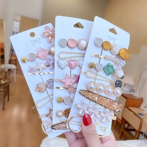 Detailed view of candy color hair clips set with pearls and star-shaped alloy elements