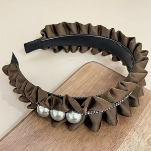 Detail of brown pleated headband with three large pearls and sparkling rhinestone trim