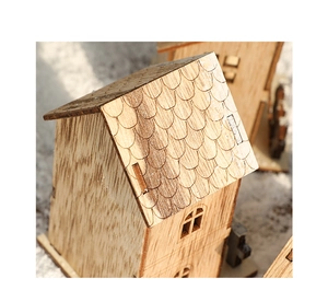 Detail of wooden Christmas house roof shingles with laser-cut wood craftsmanship