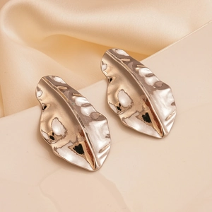 Detail showing the hammered texture and leaf shape of these silver-toned earrings