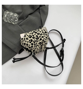 Close-up of leopard print bucket bag with drawstring and silver metal corner detail
