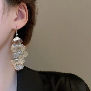 Silver multi-layer petal tassel earrings shown on model for size and drape detail