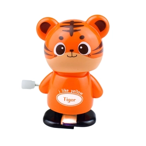 Detail of wind-up orange tiger toy with walking mechanism and side turning knob