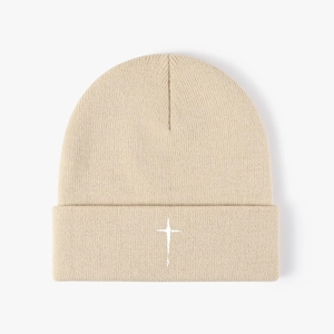 Minimalist beige knitted beanie with white cross embroidery for winter warmth