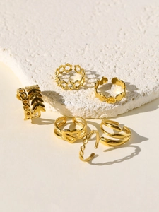 Detail view of 6-piece 18k gold plated stainless steel ring set with heart and leaf motifs