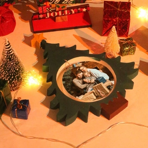 Detail view of a Christmas tree wooden photo frame on a festive warm tabletop