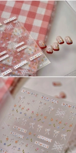 Detail of M-1087 nail stickers with floral patterns and white bows on pastel grid base