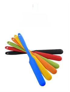 Detailed view of six colorful silicone spatulas arranged in a fan shape with hanging holes