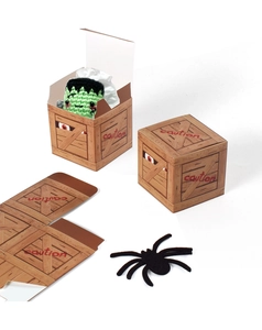 Detail of assembly stages for a pirate wood grain paper gift box for Halloween treats