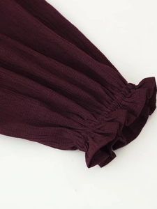 Detail of smocked elastic cuffs and ruffle edges on purple ethnic beaded textured shirt