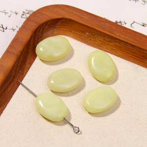 Macro detail of oval pale yellow natural stone beads for DIY jewelry making