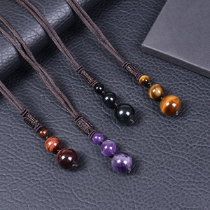 Handcrafted woven necklace cords featuring 16mm natural tiger eye and amethyst pendants