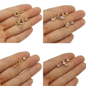 Close-up of gold heart and butterfly studs with sparkling white cubic zirconia