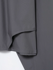 Macro detail of the double-needle stitching and dark gray twill fabric on shirt hem