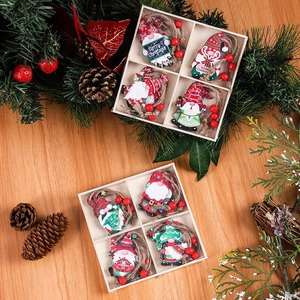 Detail of wooden Christmas gnome ornaments set with festive pine cones and red berries