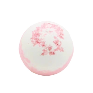 Pink and white marbleized spherical bath bomb with floral petal texture on white background