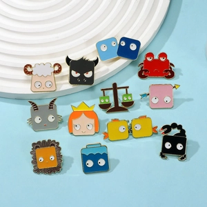 Twelve cute cartoon zodiac animal enamel pins in square shapes on a blue surface